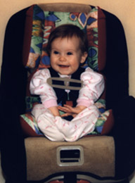 Megan, 9 months in a carseat with her Travelbud